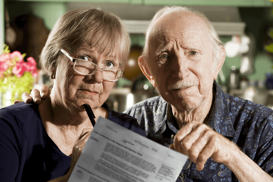 Senior couple reviewing paperwork with reservation
