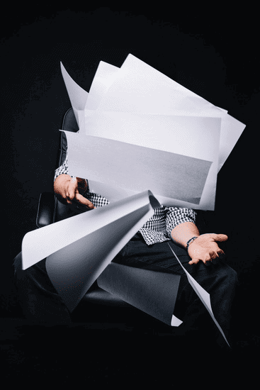 Photo of person throwing blank sheets of paper
