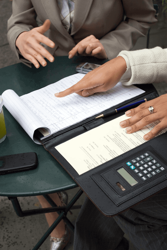 Photo of two people working at small table