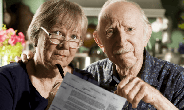 Senior couple reviewing paperwork with reservation