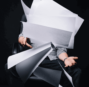 Photo of person throwing blank sheets of paper