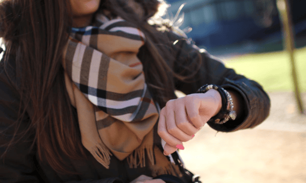 Close-up of polished female checking time on watch