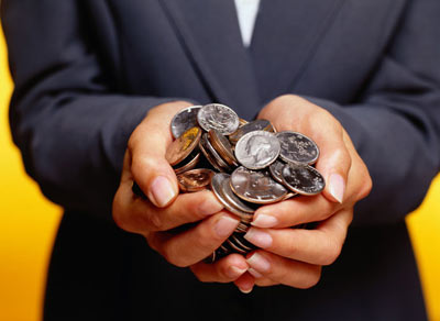 Man holding coins in cupped hands