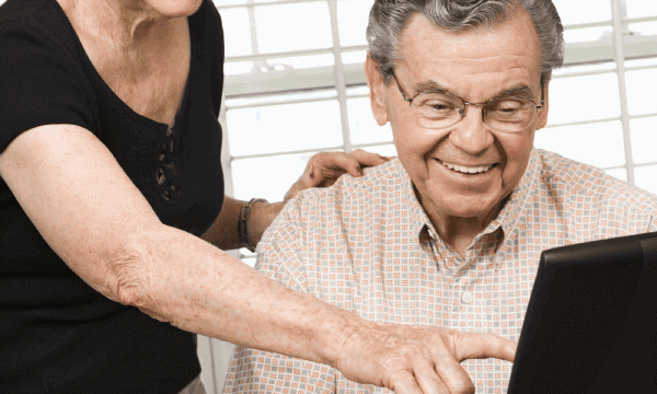 Senior couple working on laptop